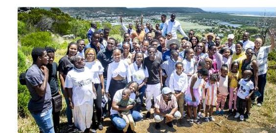 A large group of ABA campers and supporters on a hillside
